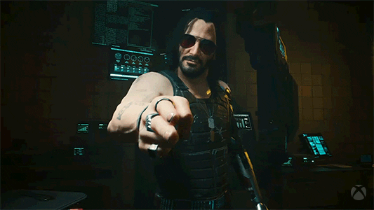 Keanu Reeves señalando a alguien en diferentes consolas gracias a la progresión cruzada que tienen juegos como Cyberpunk 2077.- Blog Hola Telcel